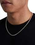 Model wearing 3mm 18k gold tennis necklace by Iceman Society, side view