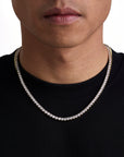 Model wearing 4mm 18k gold tennis necklace by Iceman Society, front view
