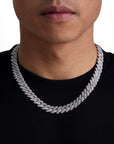 Model wearing 13mm white gold ice prong cuban chain set by Iceman Society, front view