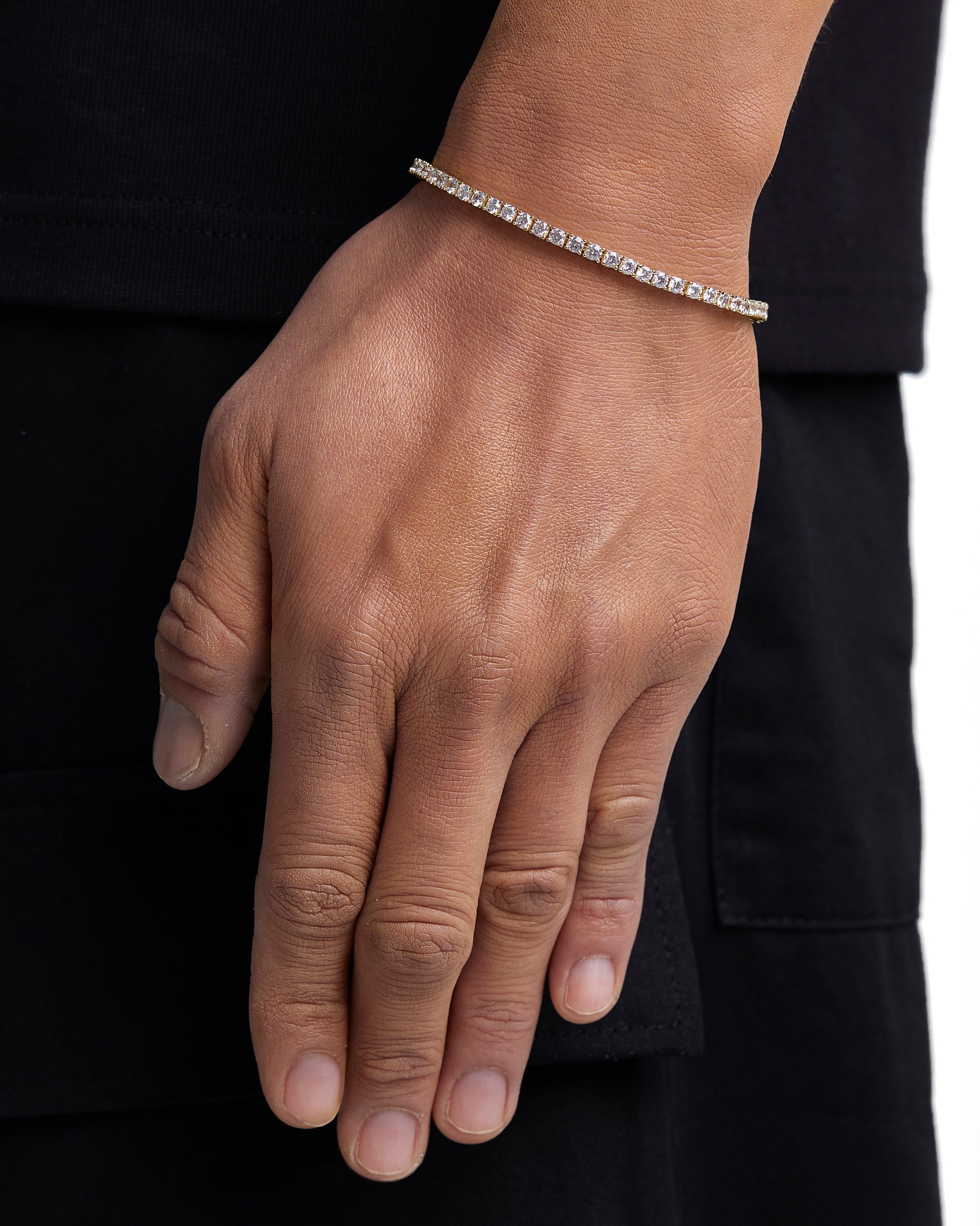 Model wearing 3mm 18k gold tennis bracelet by Iceman Society