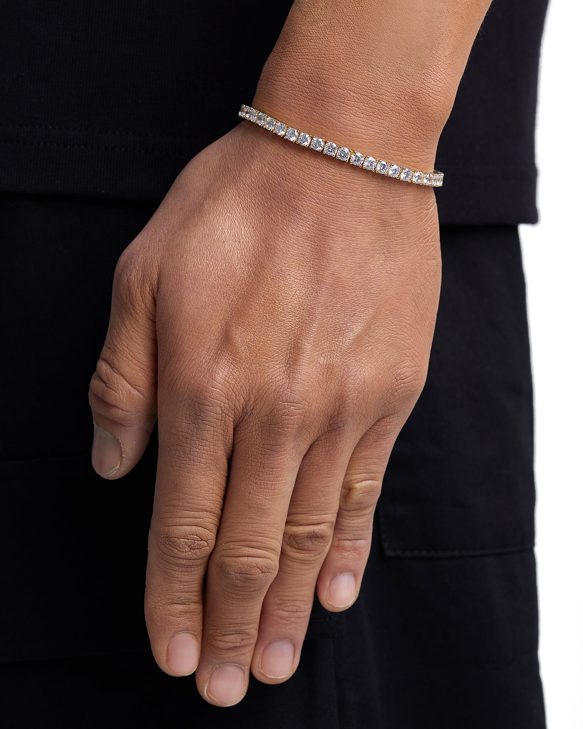 Model wearing 4mm 18k gold tennis bracelet by Iceman Society